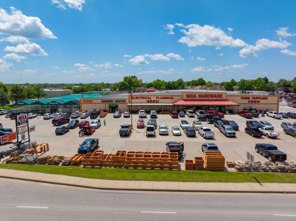 Elevated view of Nixa Hardware, its garden center, storefront, and grounds in Nixa